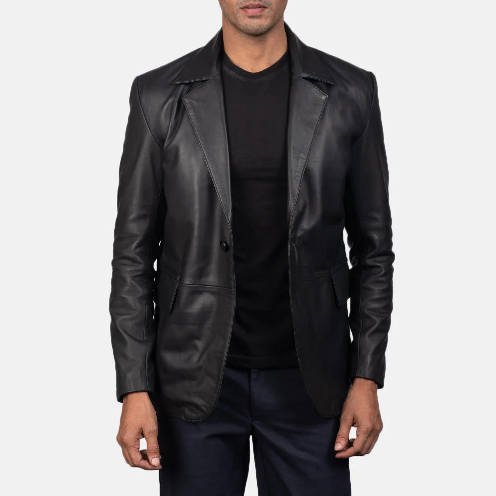 An edgy man rocking a black blazer jacket men's, adding a touch of rebellion to his look.