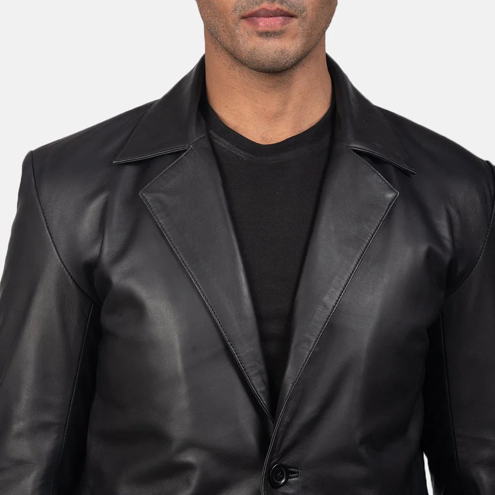 An edgy man rocking a black blazer jacket men's, adding a touch of rebellion to his look.