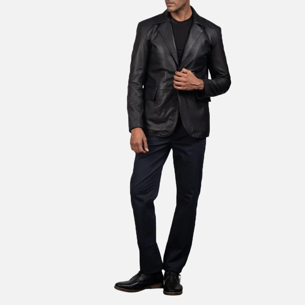An edgy man rocking a black blazer jacket men's, adding a touch of rebellion to his look.