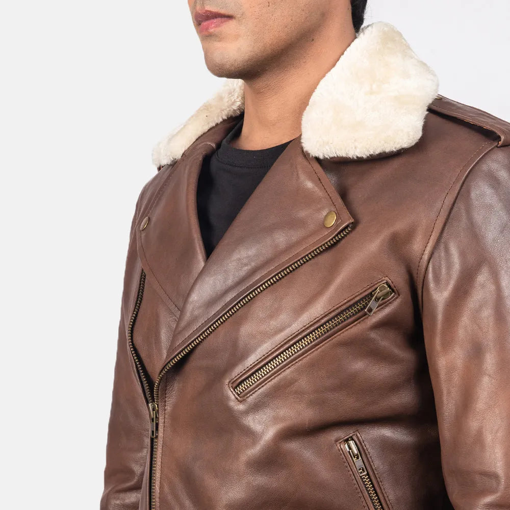 A stylish brown leather motorcycle jacket with a cozy shearling collar, perfect for adding a touch of rugged sophistication to any outfit.