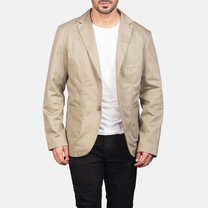 A well-dressed man in a beige cotton blazer jacket, radiating elegance and charm.