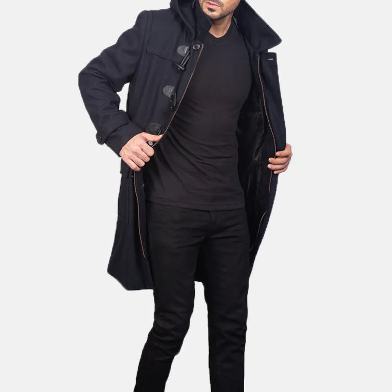 A stylish man wearing a black leather long coat and black pants.
