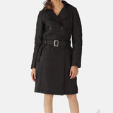 A stylish woman wearing a black leather trench coat and boots, looking confident and ready for any occasion.