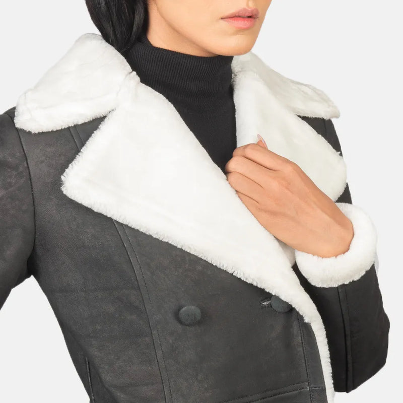 Stay cozy and chic in this black trench coat with white shearling details for women.