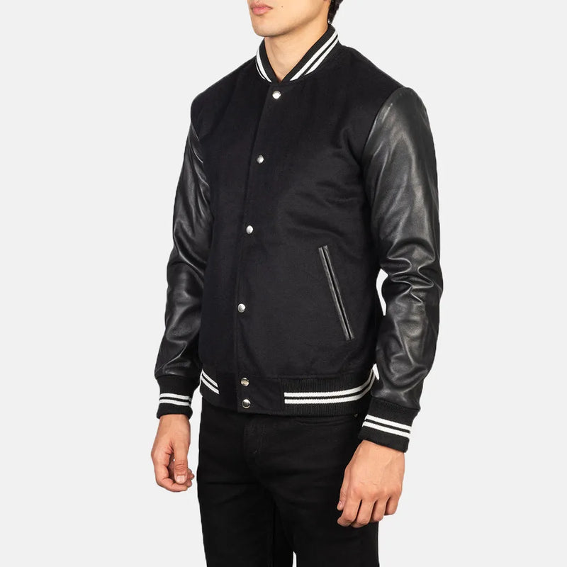 A fashionable black varsity jacket that combines a classic look with edgy leather sleeves.