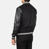 A fashionable black varsity jacket that combines a classic look with edgy leather sleeves.