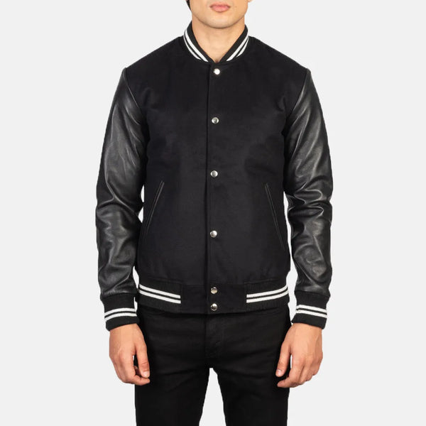 A fashionable black varsity jacket that combines a classic look with edgy leather sleeves.