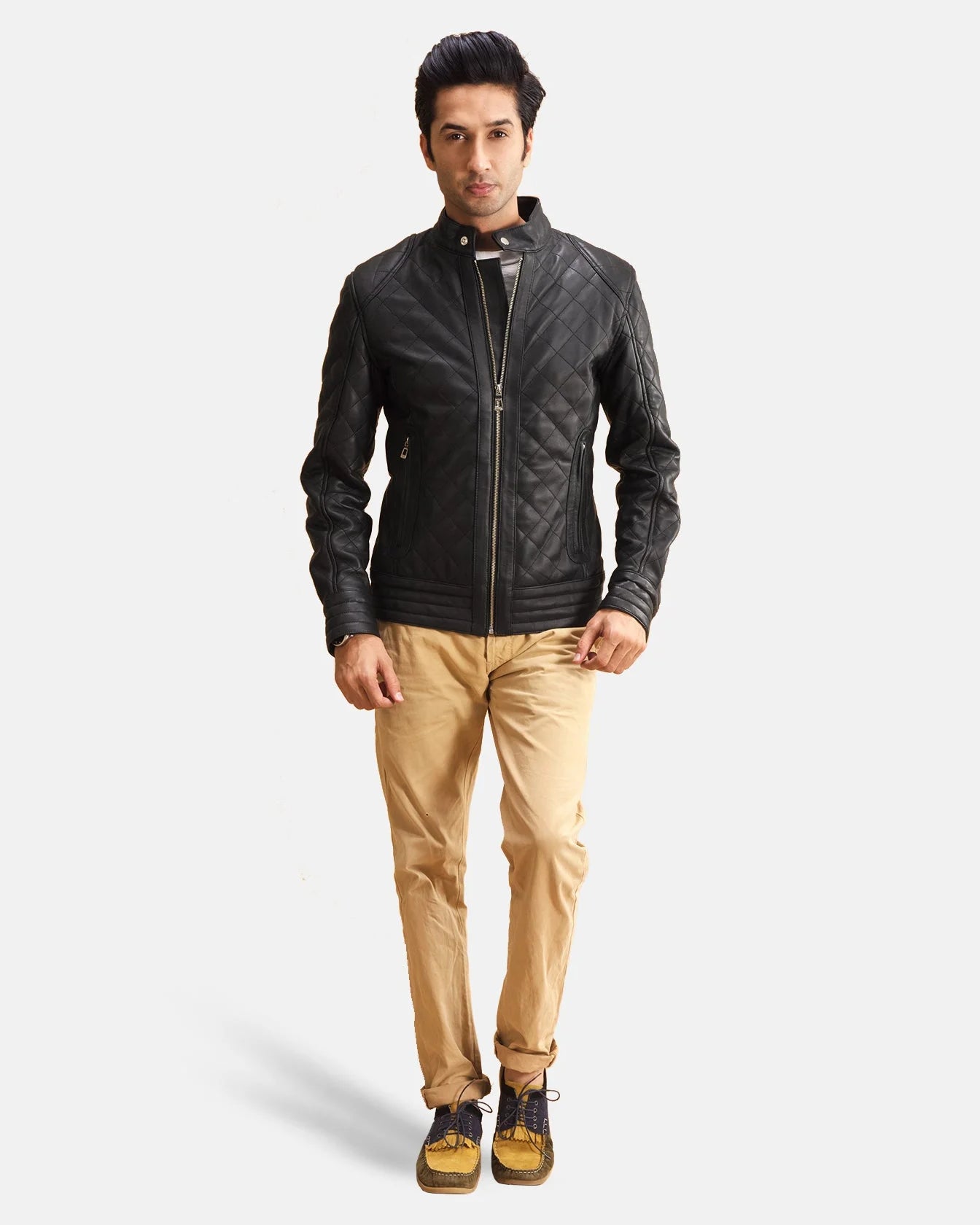 A fashionable man wearing a black zipper jacket. Ideal for a casual and laid-back vibe.