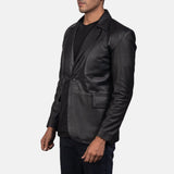  An edgy man rocking a black blazer jacket men's, adding a touch of rebellion to his look.