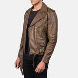 A stylish man rocking a bike leather jacket in rich brown. He exudes confidence and coolness with his fashion choice.