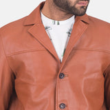 Trendy guy rocking a tan brown leather blazer jacket, showcasing his fashion sense.