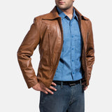 A suave man donning a brown leather shirt jacket, epitomizing timeless coolness and making a bold fashion statement.