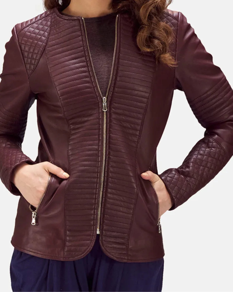 A stylish woman rocking a leather jacket maroon, exuding confidence and adding a touch of elegance to her ensemble.