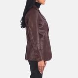 A woman wearing a maroon leather blazer, exuding elegance and style with her choice of attire.
