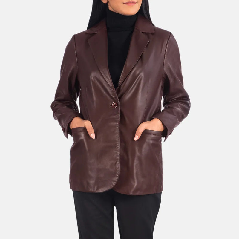 A woman wearing a maroon leather blazer, exuding elegance and style with her choice of attire.
