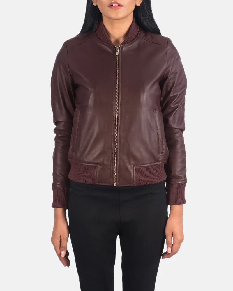  A fashionable maroon leather jacket for women, designed in a classic bomber style.