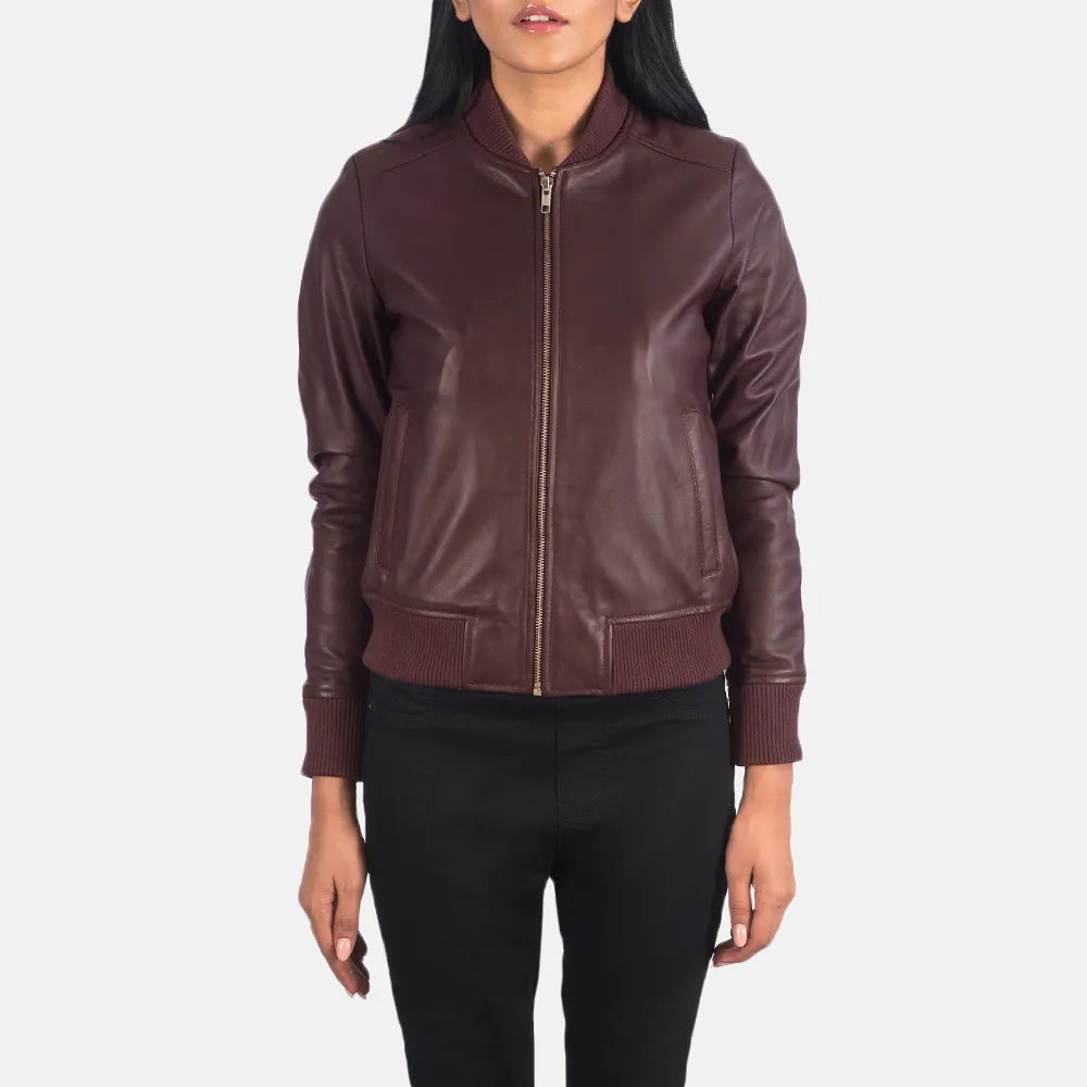  A fashionable maroon leather jacket for women, designed in a classic bomber style.