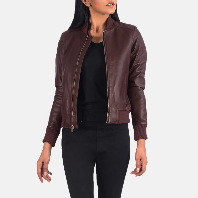  A fashionable maroon leather jacket for women, designed in a classic bomber style.