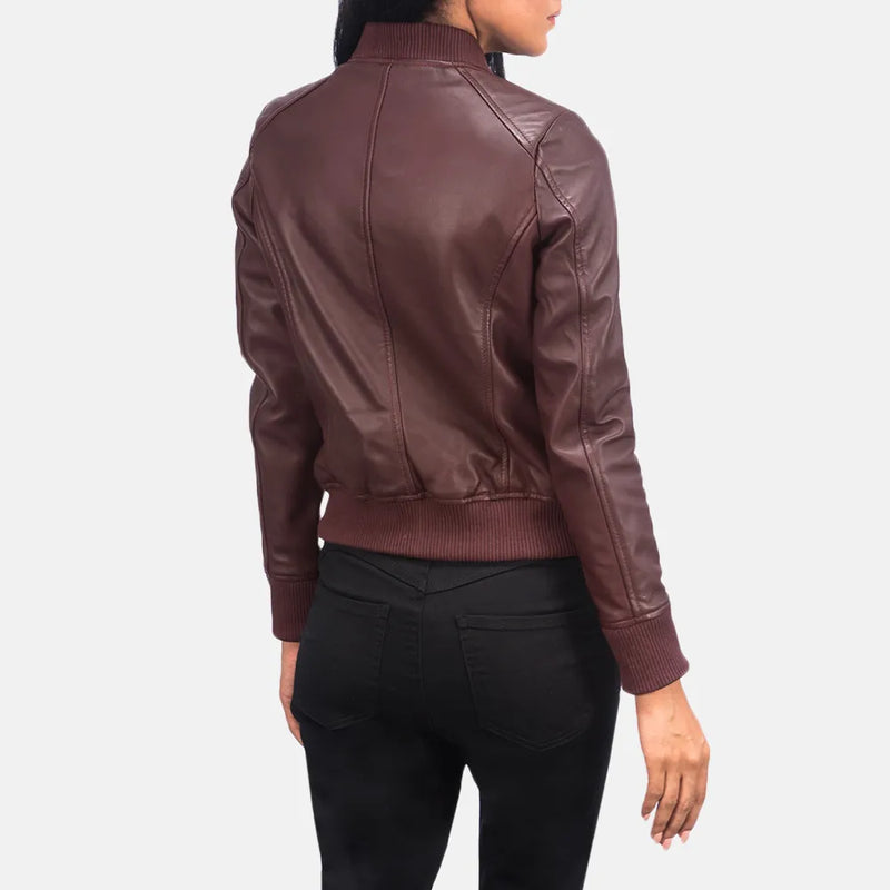  A fashionable maroon leather jacket for women, designed in a classic bomber style.