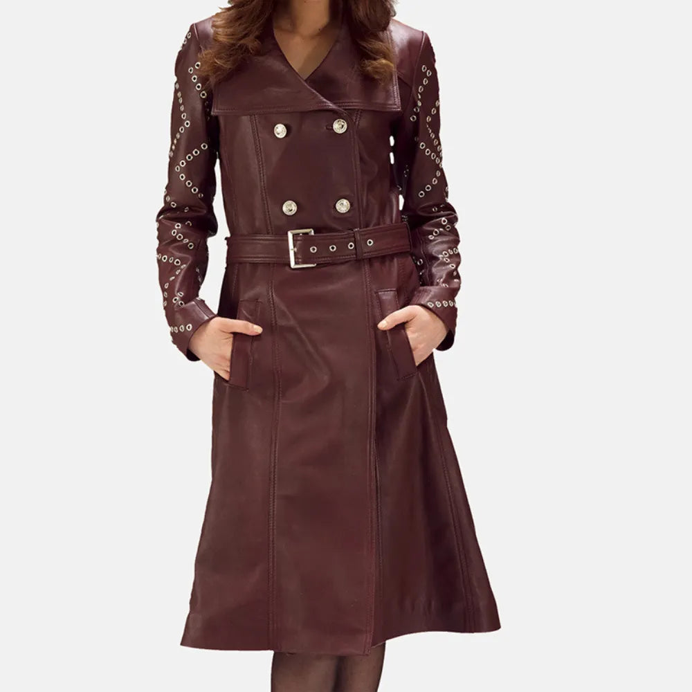 A stylish woman wearing a maroon leather trench coat, looking confident and fashionable.