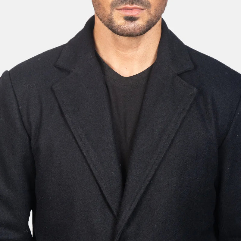 A man wearing a black coat and pants. He is dressed in a Men's Black Leather Coat.