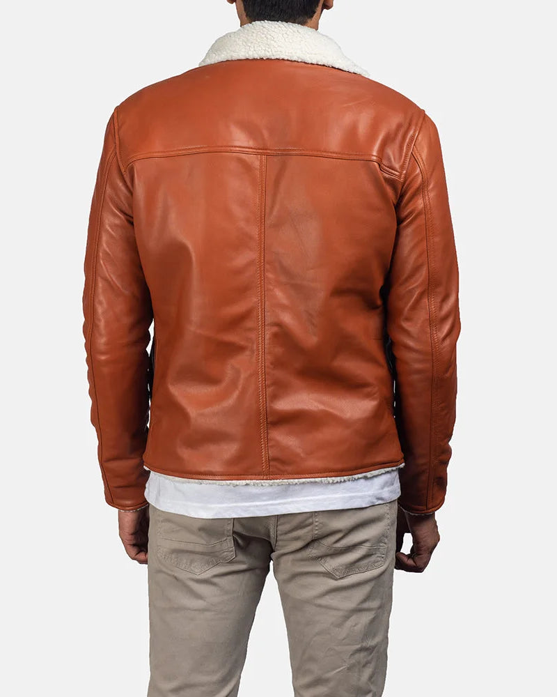 Handsome man wearing a tan suede leather jacket, looking effortlessly cool.