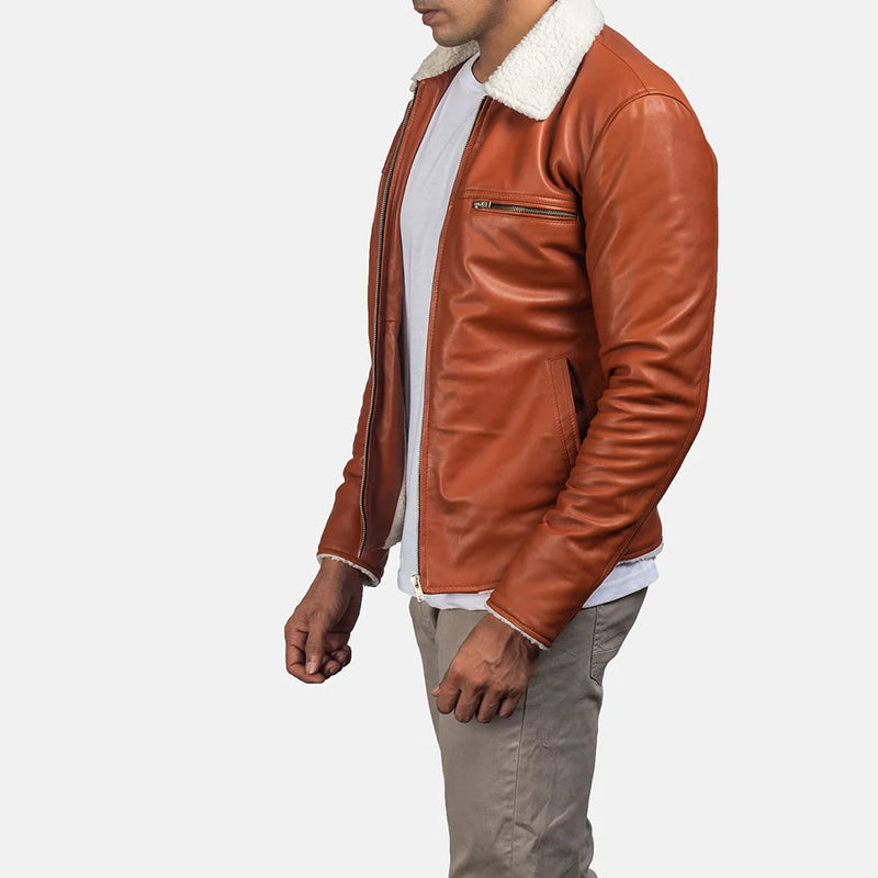 Handsome man wearing a tan suede leather jacket, looking effortlessly cool.