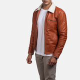 Handsome man wearing a tan suede leather jacket, looking effortlessly cool.