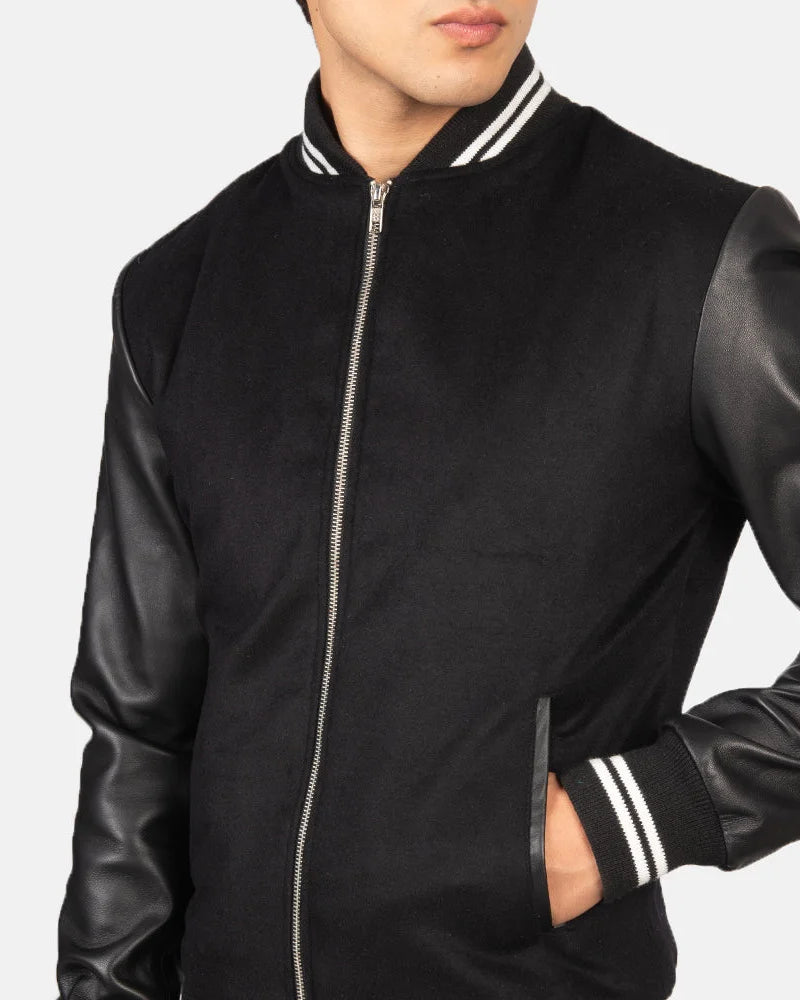 A stylish black striped varsity bomber jacket with a zipper and a collar, perfect for adding a touch of coolness to any outfit.