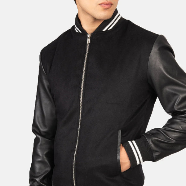 A stylish black striped varsity bomber jacket with a zipper and a collar, perfect for adding a touch of coolness to any outfit.