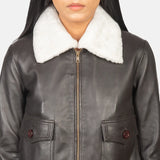Fashionable women's leather style jacket featuring collar and cuffs.
