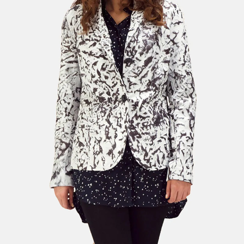 Fashionable woman donning a black and white jacket, featuring a white leather blazer.